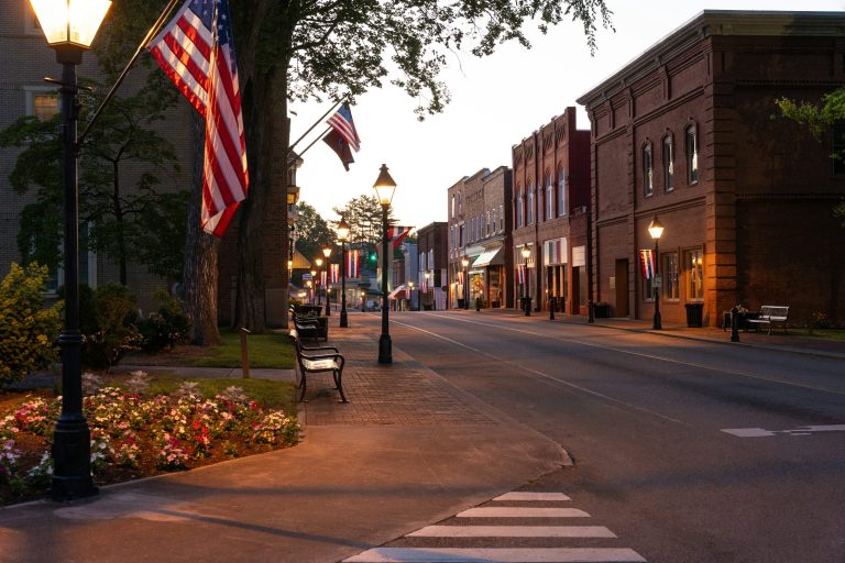 Empty main street in a small American town at dusk.