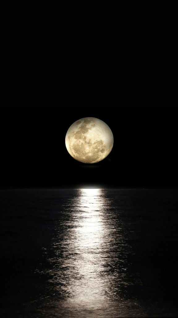 full moon reflecting over a dark sea symbolizing silence, distance, and the fragile moment before human decision in times of global risk