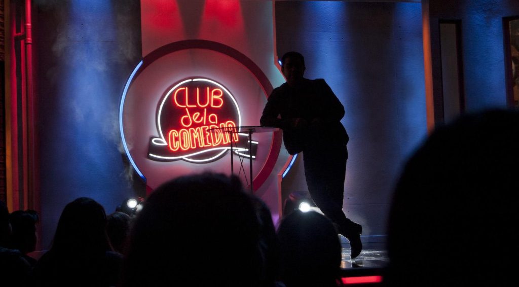 stand-up comedian on stage with audience representing human humor and live performance